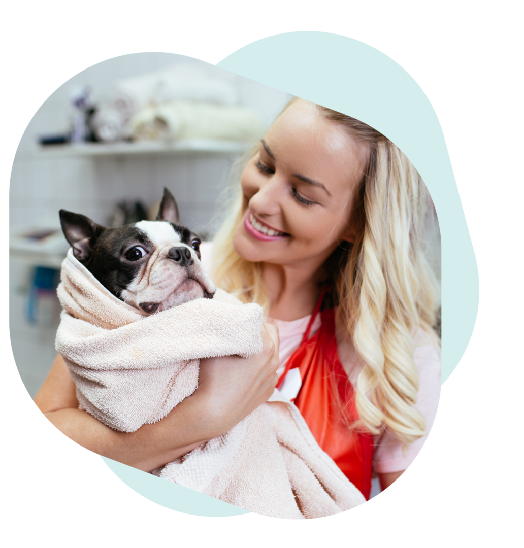 A woman holding a dog in her arms.